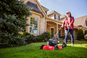 Photo of CRAFTSMAN lawn mower CM11A-02T8793 in use on grass in front of a house.