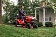 Photo of a Craftsman riding lawn mower CM13BL78XTA93 cutting grass in a residential yard.