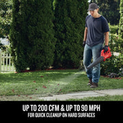 Photo of Craftsman cordless leaf blower CMCBL710D1 clearing leaves from grass near sidewalk.