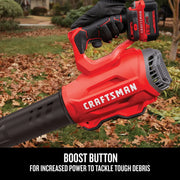 Photo of Craftsman cordless leaf blower CMCBL720B held by gloved hand outdoors, showing boost button feature.