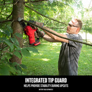 Photo of Craftsman CMCCS320B cordless chainsaw cutting tree branch outdoors, person wearing gloves using tool.