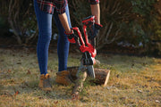 Photo of Craftsman cordless chainsaw CMCCSL621B cutting a small log outdoors.