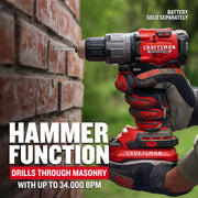 Photo of Craftsman cordless hammer drill CMCD726B used on brick wall, gloved hands holding tool outdoors.
