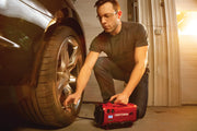 Photo of CRAFTSMAN portable inflator CMCE520B being used to inflate a car tire in a garage.