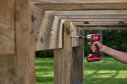 Photo of Craftsman CMCF830B impact driver drilling screw into wooden deck frame outdoors.