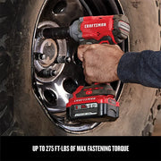 Photo of Craftsman cordless impact wrench CMCF920B in use removing a lug nut on a vehicle wheel.