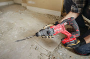 Photo of a Craftsman cordless rotary hammer, SKU CMCH234B, held by a person removing floor tiles in a renovation.