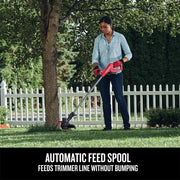 Photo of Craftsman CMCK279C2 string trimmer in use on grass by a person near a white fence and tree.