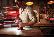 Photo of Craftsman cordless LED light CMCL050B in use on a workbench in a workshop setting.
