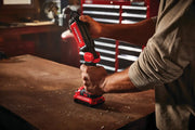 Photo of a person using a Craftsman cordless work light, SKU CMCL050B, on a wooden workbench in a workshop.