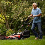 Photo of CRAFTSMAN lawn mower CMCMW220P2 being pushed on grass in a garden setting.