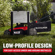 Photo of Craftsman lawn mower CMCMWSP220P2 with low-profile design, fitting under a planter in a grassy yard.