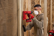 Photo of Craftsman CMCN410B cordless nailer in use by a worker on wood framing, red tool and gloves visible.