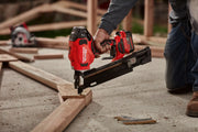 Photo of Craftsman cordless framing nailer, model CMCN621PLB, being used on wood frame at a construction site.