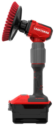 A red and black handheld power scrubber with a round bristle brush attachment, labeled 'Craftsman' on the side, standing upright against a white background.
