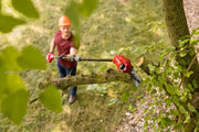 Photo of Craftsman pole saw CMCPS630D1 cutting a tree branch outdoors, shown in use from above.