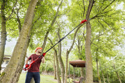 Photo of CRAFTSMAN CMCPS630D1 pole saw being used outdoors for pruning tree branches.