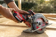 Photo of CRAFTSMAN CMCS551B circular saw in use on a wood plank in a workshop setting with shelving.