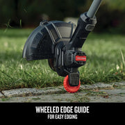 Photo of Craftsman CMCST915B string trimmer edge guide wheel on grass, close-up outdoor angle.