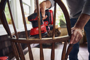 Photo of Craftsman cordless sander CMCW221B sanding a wooden chair, handheld in a home setting.