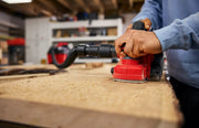 Photo of Craftsman CMCW350B sander in use on wood surface in workshop, close-up view.
