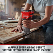 Photo of a person using a Craftsman cordless router CMCW400B on a wooden board, sawdust scattered on workbench.