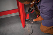 Photo of CRAFTSMAN corded drill CMED741 used to drill into a red metal frame on a workshop floor.