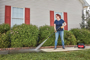 Photo of Craftsman pressure washer CMEPW1700 cleaning a walkway outside a house with red shutters.