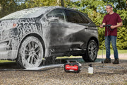 Photo of Craftsman CMEPW1800 pressure washer in use cleaning a car, outdoor setting, front angle visible.