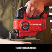 Photo of Craftsman jigsaw CMES610 in use, red and black color, handheld cutting wood.