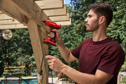 Photo of Craftsman cordless drill CMGL200B used on outdoor wooden frame by person in maroon shirt.