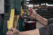 Photo of worker using Craftsman screwdriver CMHT26163V with red handle on industrial machine.