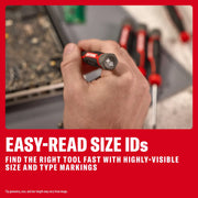Hand holding a CRAFTSMAN screwdriver with visible size ID on handle, other screwdrivers and tools in background.