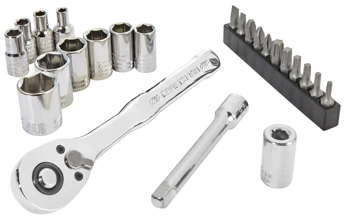 A set of shiny chrome ratchet wrenches, sockets, a socket extension, and various screwdriver bits arranged on a white background.