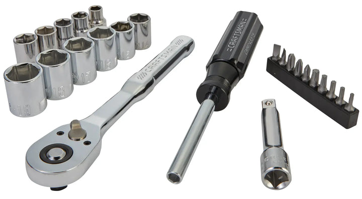 A set of Craftsman hand tools including a ratchet wrench, several chrome sockets, a screwdriver handle, an extension bar, and a set of screwdriver bits organized in a holder, all arranged on a white background.