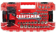 A red and transparent plastic tool case labeled 'CRAFTSMAN' containing a variety of mechanic's tools, including socket wrenches, sockets, hex keys, and ratchets, all neatly organized in individual compartments.