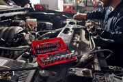 Photo of CRAFTSMAN socket and bit set CMMT45751V in red case on car engine, mechanic working in background.
