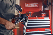 Photo of Craftsman hand tool in use on motorcycle handlebars, SKU CMMT87021, with red Craftsman tool chest in background.