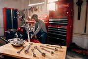 Photo of Craftsman wrenches CMMT87024 on a workbench in a garage with red tool storage in the background.