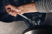 Photo of Craftsman CMMT87024 ratcheting wrench in use on automotive part, close-up angle.