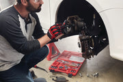 Photo of Craftsman tool set SKU CMMT98283 open on floor next to a person repairing a vehicle brake system.