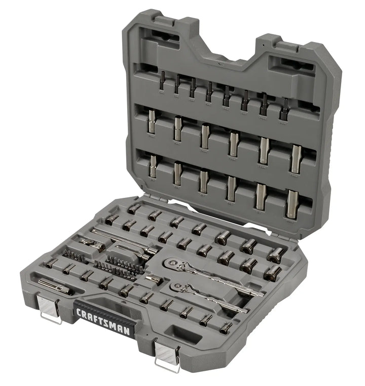 A gray plastic carrying case containing a variety of metal socket wrenches, bits, and ratchets organized in molded compartments. The case is open to show the tool set, which includes different sizes and types of sockets and attachments for mechanical and automotive work. The brand name 'Craftsman' is visible on the front of the case.