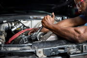 Photo of Craftsman CMMT99154L ratchet wrench used on a car engine in a close-up repair setting.