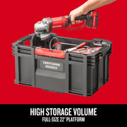 Photo of CRAFTSMAN large black VersaStack XL toolbox CMST21409 with tools inside, hand placing power tool, front angle.