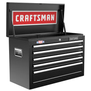 A black metal tool chest with six drawers, a side handle, and an open top lid. The inside of the lid features a large red and white 'CRAFTSMAN' logo, and there is a sticker that reads 'USA' on the front.