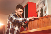 Photo of Craftsman red tool cabinet, SKU CMST27200R, with pegboard and tools in workshop setting.