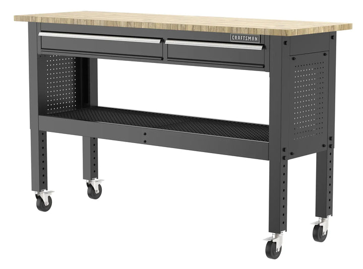 A rolling workbench with a wooden top, two metal drawers, perforated side panels, a lower metal shelf, and four locking caster wheels. The brand logo 'Craftsman' is visible on the front.