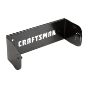 Photo of CRAFTSMAN black metal wall mount bracket with cutout logo, SKU CMST82695, shown at an angle on white.