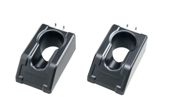 Photo of two black Craftsman battery charger bases, model CMST98257, angled on a white background.