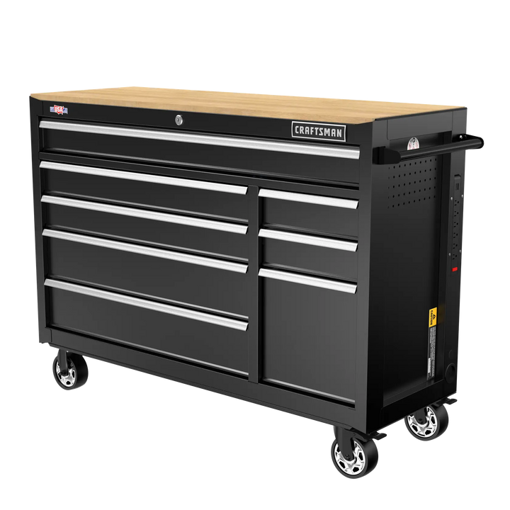 A large black rolling tool chest with multiple drawers and a wood top, designed for organizing and storing tools. The chest has lockable drawers, a side handle, wheels for mobility, and a 'Craftsman' brand label on the front.